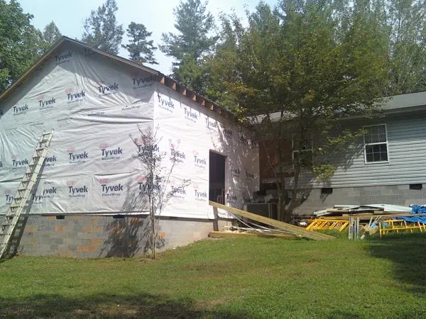 Tyvek wrapped gable on a new room addition beside an existing home in Shady Valley